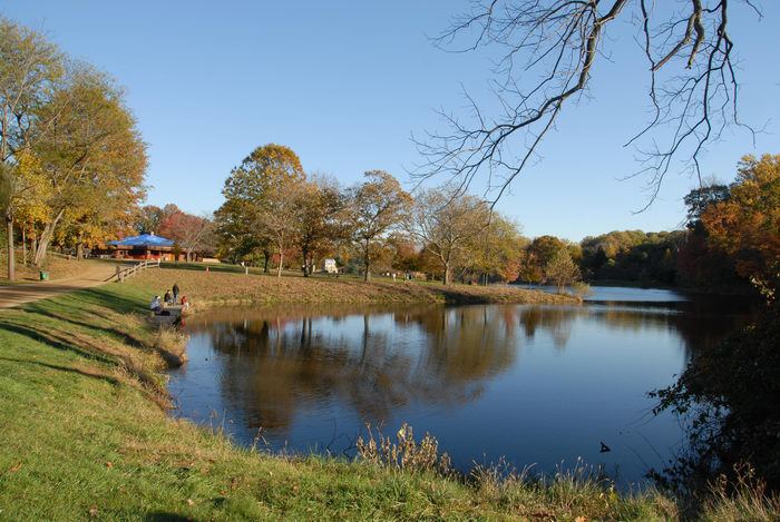 blue sky, building, fall colors, grass, open areas, pond, reflection, trees, water