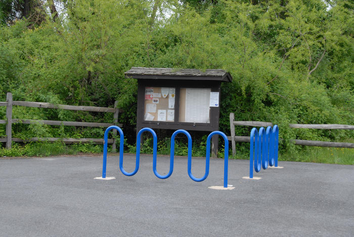 bike holder, fence, sign, trees