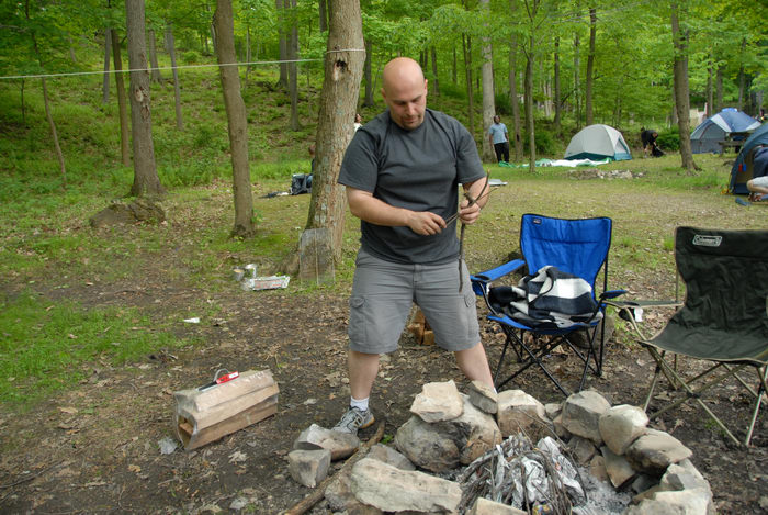 Jeff, camping chair, fire ring, grass, kindling, tent