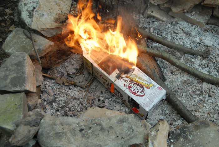 Dr Pepper box, fire, fire ring, sticks