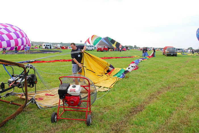 grass, field, fan, blowing up, deflated hot air balloon