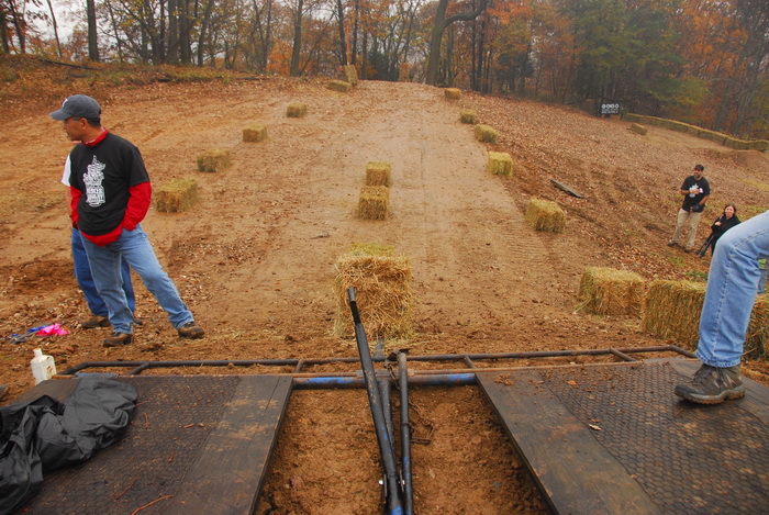 race track, starting gate, hay bales
