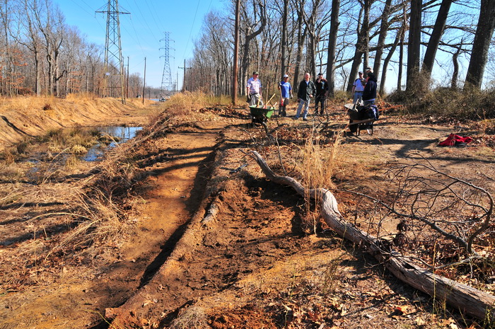 dirt trail, grass, new trail, people, power lines, stick, tail maintenance, trail workers, water, wood