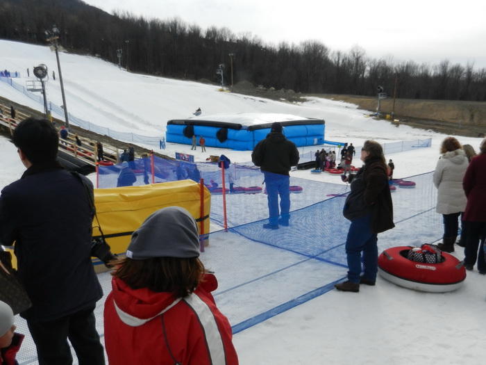 blow up landing mat, crowd, fence, launch ramp, people, safety fence, snow, Jackie